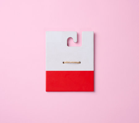 Empty white cardboard tag on brown rope, pink backgroundの写真素材