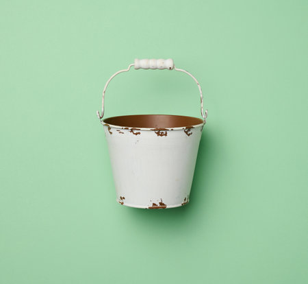 Miniature small white bucket on a green background, top viewの写真素材