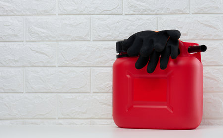 Red plastic canister for liquid fuels and lubricants on a white background