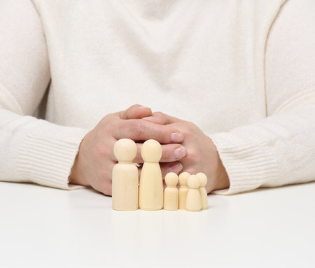 Wooden figurines of the family, the concept of family insurance, state protectionの写真素材