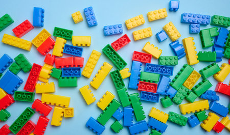 Multi-colored plastic cubes of a children's designer on a blue background, top viewの写真素材