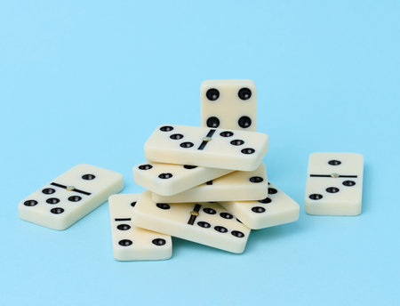 A stack of dominoes on a blue background, an intellectual gameの写真素材