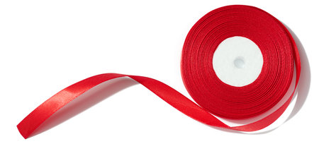 A spool with a red silk ribbon on a white isolated background, an object for decorationの写真素材