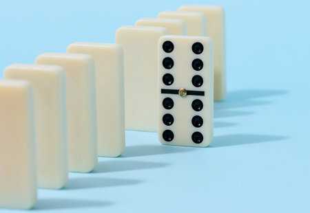 A stack of dominoes on a blue background, an intellectual gameの写真素材