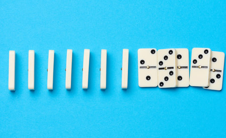A stack of dominoes on a blue background, an intellectual game. top viewの写真素材