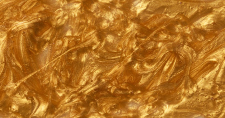 Sample of golden glitter gel with small particles, texture of highlighter cosmeticsの写真素材