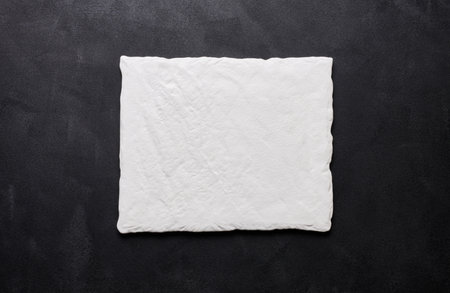 Empty white square ceramic plate on black background, top viewの写真素材