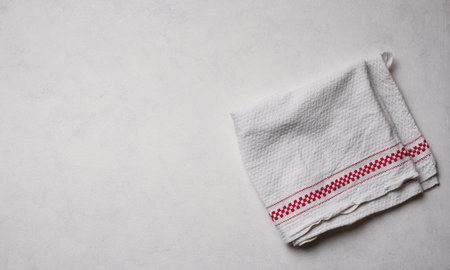 Folded white kitchen towel on a white background, top viewの写真素材
