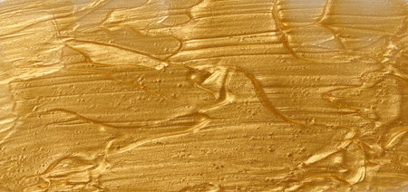 Sample of golden glitter gel with small particles, texture of highlighter cosmetics, lipstick, blushの写真素材