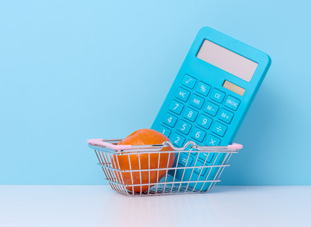 Miniature shopping cart and calculatorの写真素材