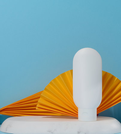 White plastic tube for liquid cosmetics on a blue background, packagingの写真素材