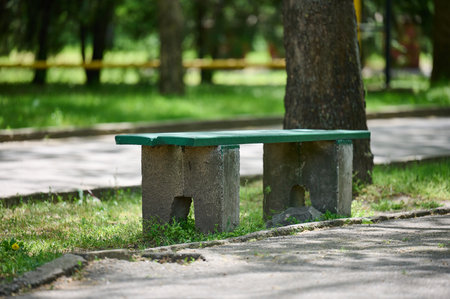 Empty stone bench in the city gardenの写真素材