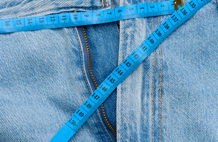 Jeans and centimeter, weight loss concept, close upの写真素材
