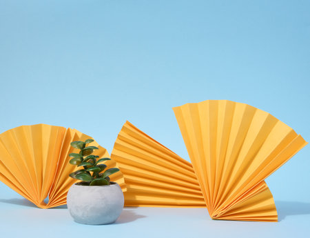 Abstract blue background with paper yellow figures, a stage for demonstrating products, cosmetics. advertising and promotionの写真素材