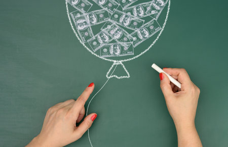 Chalk-drawn balloon with drawn dollars and female hands, concept of inflationの写真素材