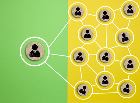 Wooden round block with staff icon which link connection network for organization structure social network and teamwork concept, top viewの写真素材