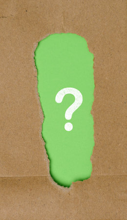 Question mark in a torn brown paper frameの写真素材