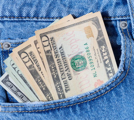 Paper American dollars in the front jeans pocket,