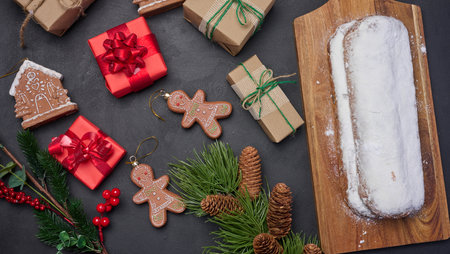 Christmas pastries stollen sprinkled with powdered sugar on the table, festive dessertの写真素材