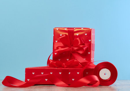 Stack of red gift boxes on blue backgroundの写真素材