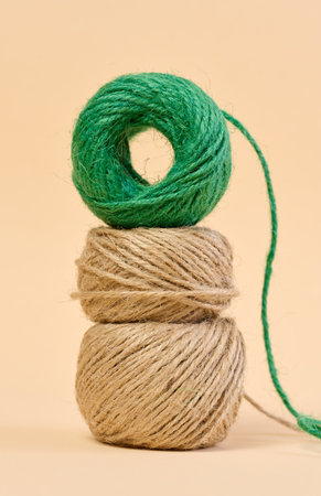 Skein of green and brown thread on a beige backgroundの写真素材