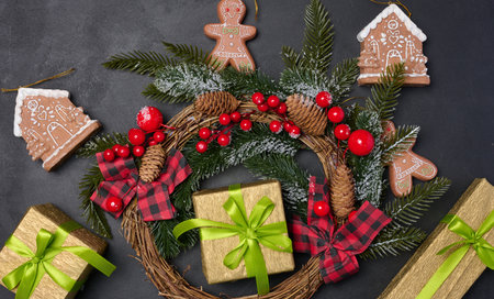 Christmas wreaths, fir branches and gifts on a black background. View from aboveの写真素材