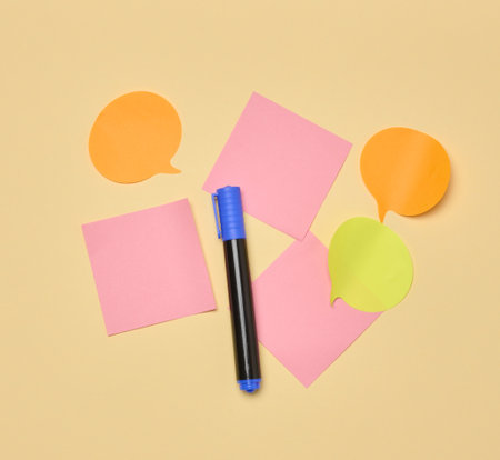 Various paper stickers and felt-tip pens on a yellow background, top viewの写真素材