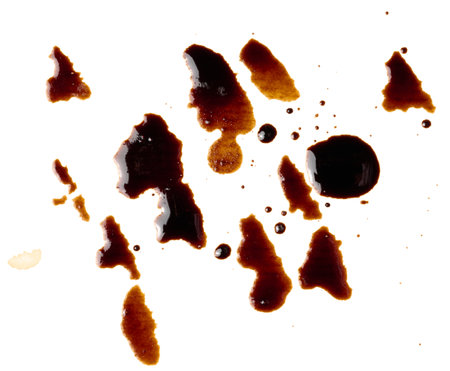 Spilled black coffee, splashes on a white background, close upの写真素材