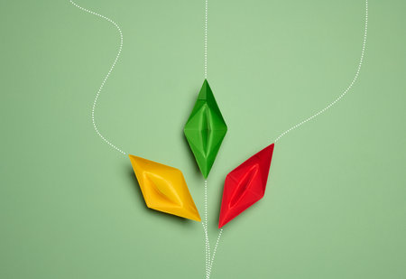 Paper boats on a green background with paths of movement, representing the concept of individuality....