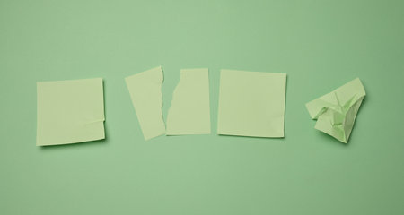 Green square sticks are glued to the green background, copy spaceの写真素材