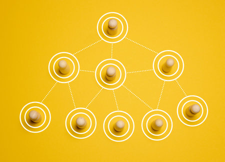 Wooden figures connected by lines, concept of delegation and hierarchy in a company, top viewの写真素材