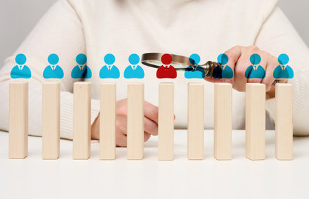 Recruitment concept, woman with magnifying glass conducting candidate selectionの写真素材