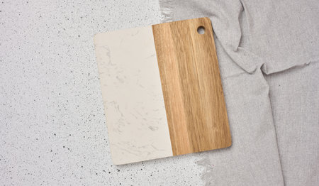 Empty wooden kitchen cutting board on a white background, top viewの写真素材