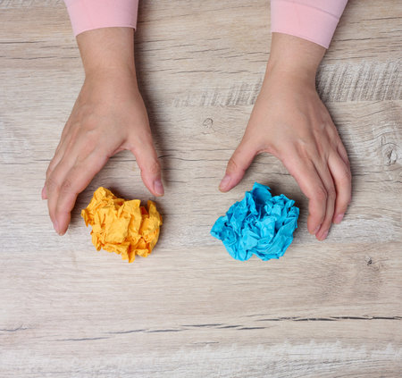 A woman's hand holding a crumpled sheet of paper, symbolizing the concept of new ideas and creativity.の写真素材