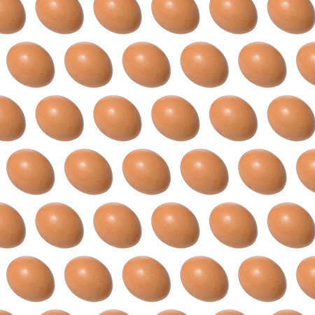 Repeating pattern of raw brown chicken eggs on isolated backgroundの写真素材