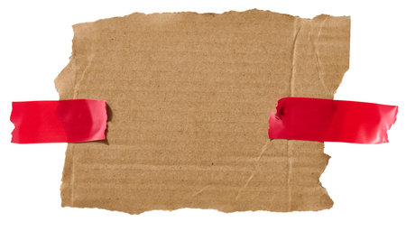 Torn piece of white corrugated cardboard attached to red piece of tape, isolated background. Copy spaceの写真素材