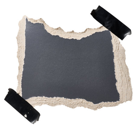 Torn piece of black cardboard attached to black piece of electrical tape, isolated backgroundの写真素材