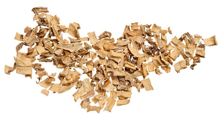 A close-up of dried vegetable pieces, including onion, beetroot, and carrot on isolated background....