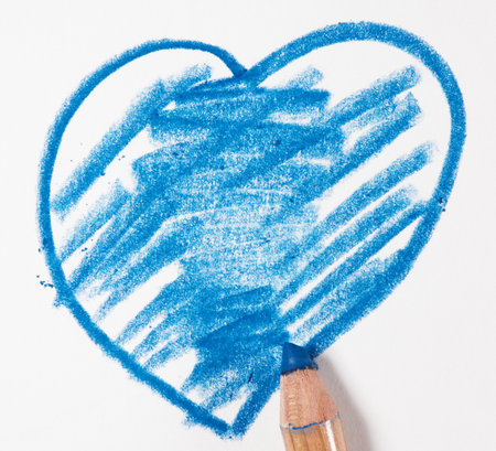 Heart drawn with blue pencil on white paper, close upの写真素材