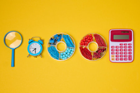 Vibrant collection of colorful school supplies and learning items on a yellow background. Play and...