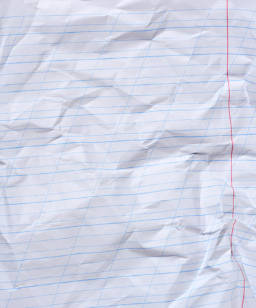Crumpled sheet of white lined paper with a red borderの写真素材