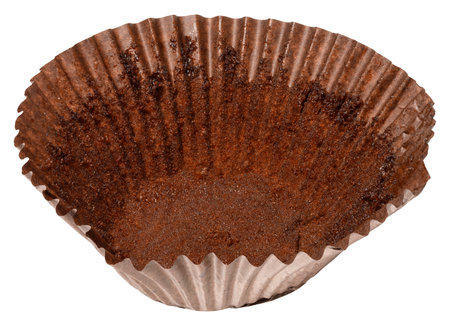 Close up of empty brown paper cupcake or muffin tin with chocolate residue, isolated backgroundの写真素材