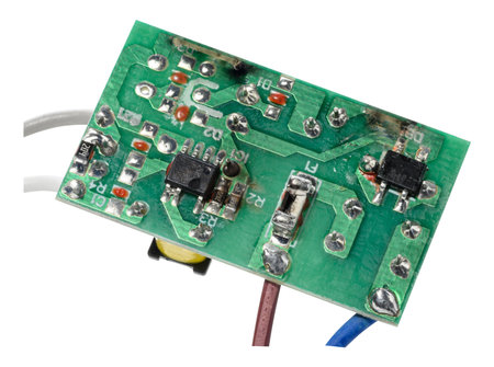 Green electronic board with various components and several wires connected, isolated on background