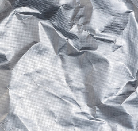 Crumpled silver foil texture, full frameの写真素材