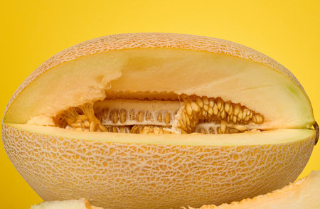Close-up of a cut cantaloupe melon focusing on the texture of the flesh and seeds.の写真素材