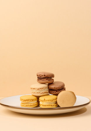 Multicolored almond macarons on a beige background