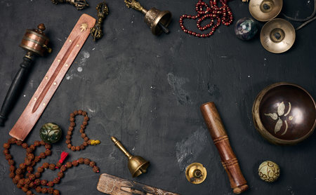 Tibetan singing bowl, wooden resonator, ritual vajras, bell, prayer wheel, rosary beads, and incense...