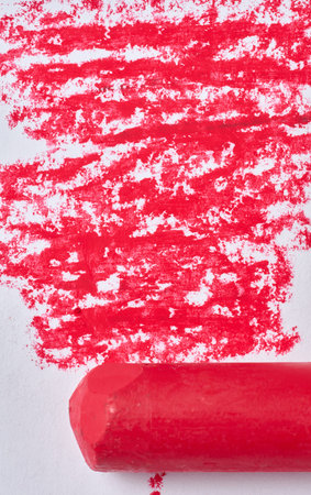 Red pastel chalk and textured stroke on white paper, close upの写真素材