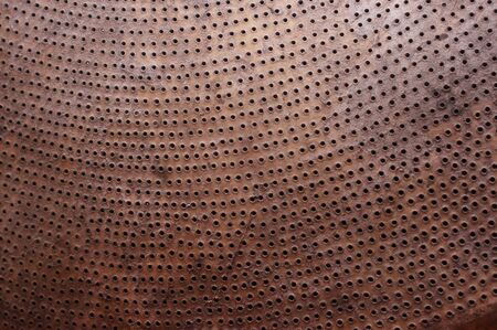 Cardboard with small holes. Ideally as backgroundの写真素材