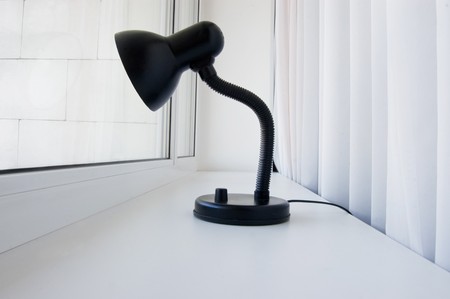 Lonely black lamp peers into the windowの写真素材